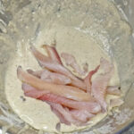 Lägg fisken i frityrsmeten och blanda