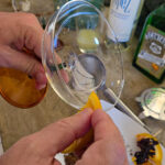 Fukta glasets kant med en bit apelsin eller lime